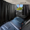 Interior view of a car with black privacy curtains covering the windows and blue leather seats.