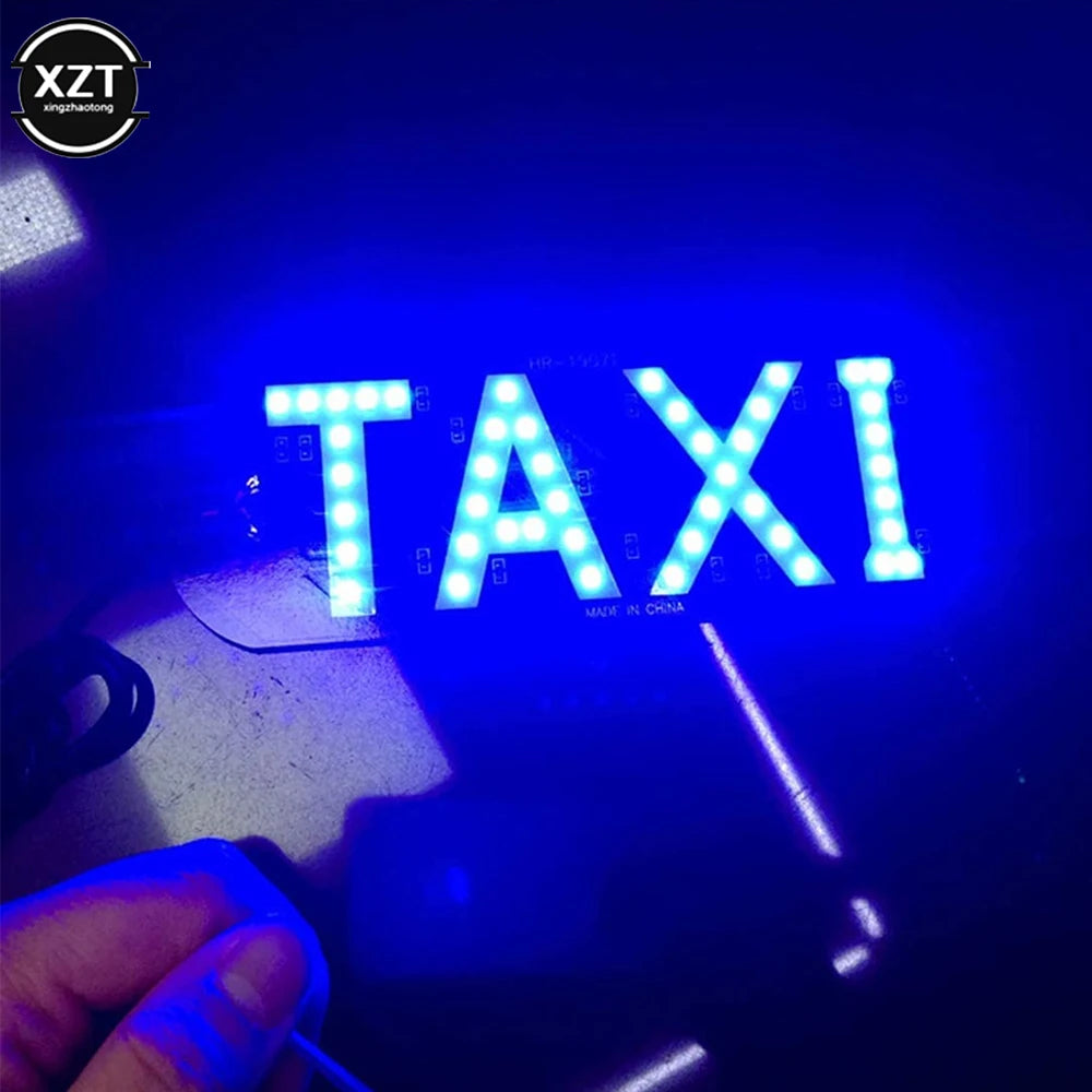A close-up shot of a bright blue LED taxi indicator light illuminating the word TAXI on a surface.