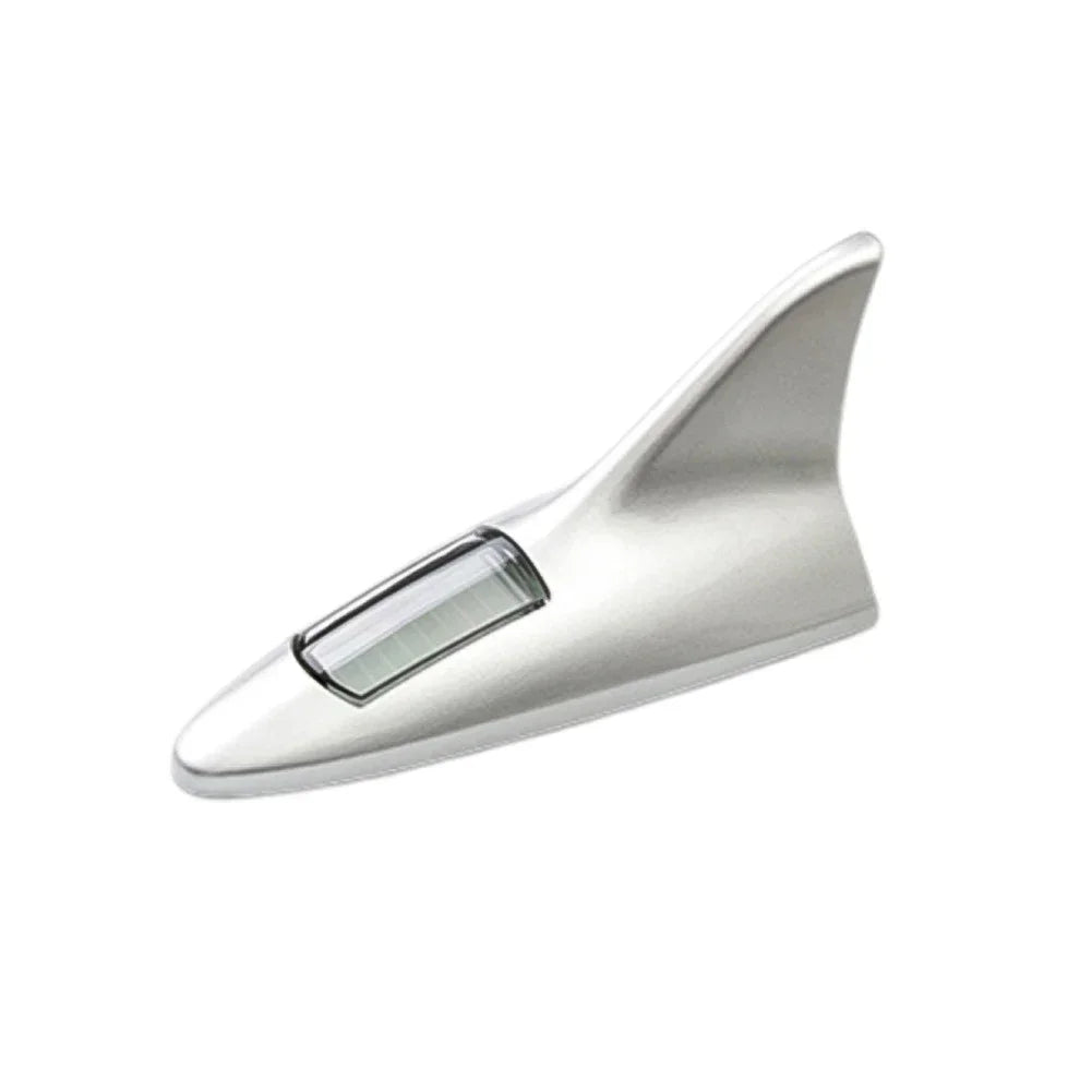 Silver shark fin roof light antenna for a solar car.
