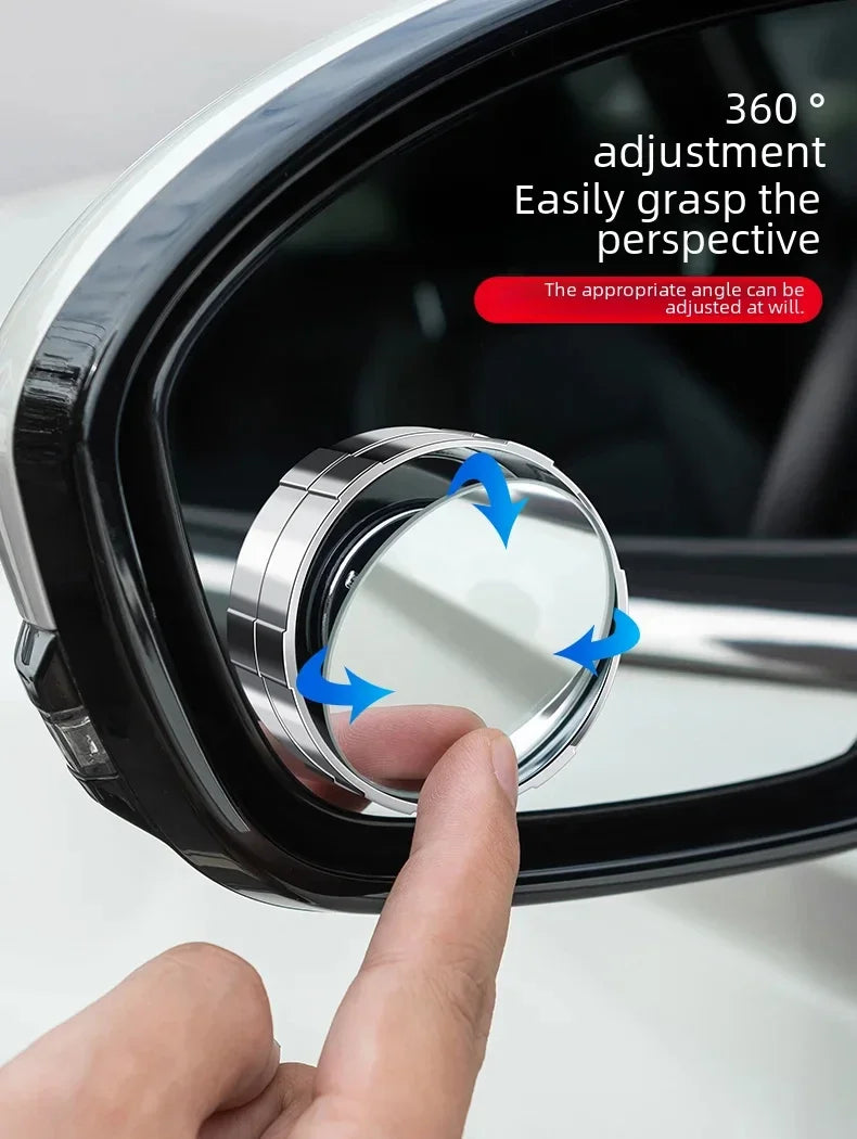 A hand adjusts a 360 degree rotating suction cup blind spot mirror for a car.