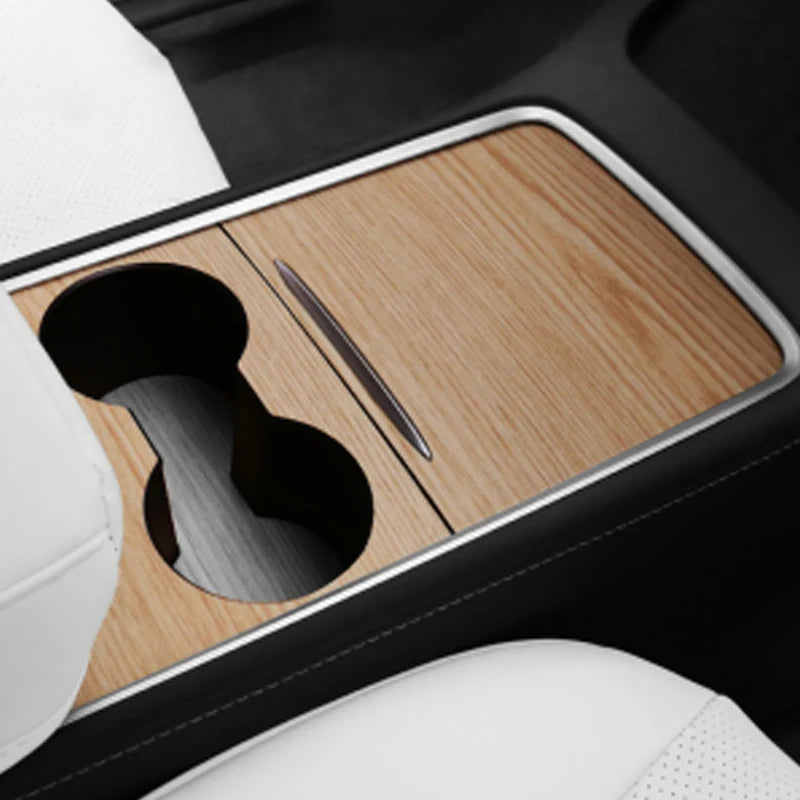 A wood grain dashboard cover is shown inside a car interior, next to a white seat cushion.