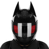 Black full face motorcycle helmet with prominent pointed horns and a red visor