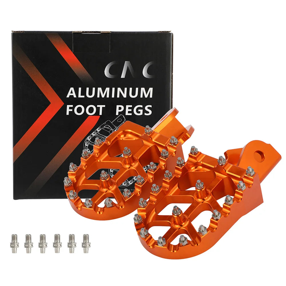 A box and set of orange aluminum foot pegs for motorcycles with mounting hardware.