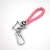 A pink braided leather key cover with a silver clasp and charm, designed for universal car keys.