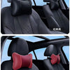 Close-up view of black and red universal car headrest pillows for neck comfort in a vehicle interior.