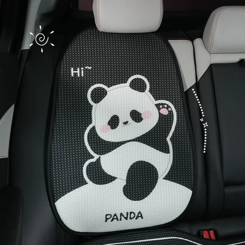 A black and white cartoon panda design on a car seat cushion.