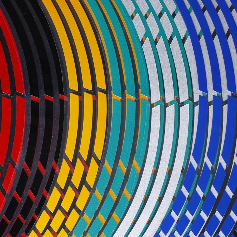 Close-up of colorful reflective wheel rim strips arranged in concentric arcs.