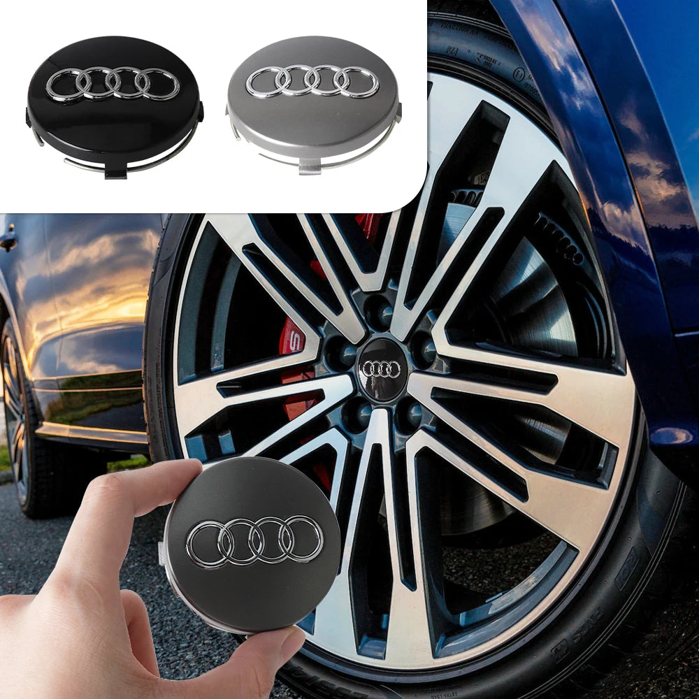 Tapaceros decorativos centrales para Audi y Porsche en negro y plata en una rueda de coche.