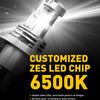 A close-up of a customized ZES LED chip headlight bulb shining brightly against a dark background.