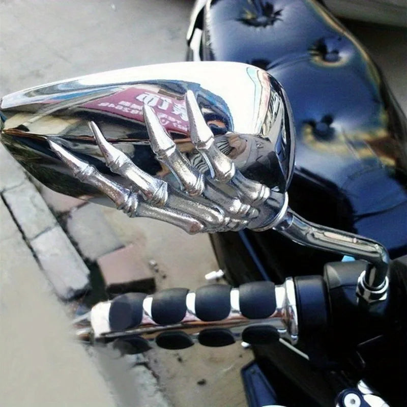 A close-up view of a chrome motorcycle rear view mirror set with multiple spikes and a reflective surface.
