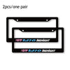 Two black license plate frame decorations with white text Midnight