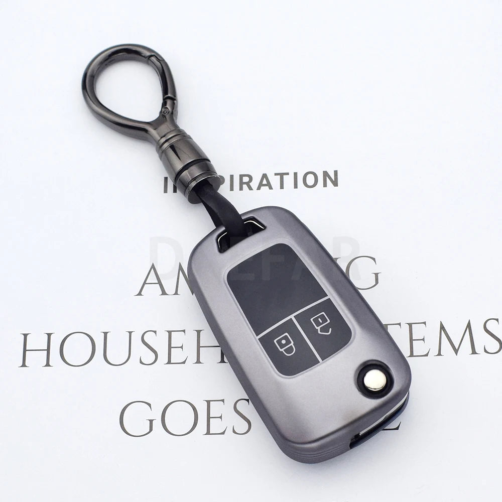 A close-up view of a dark gray universal car key cover with a metal loop and a plastic body.