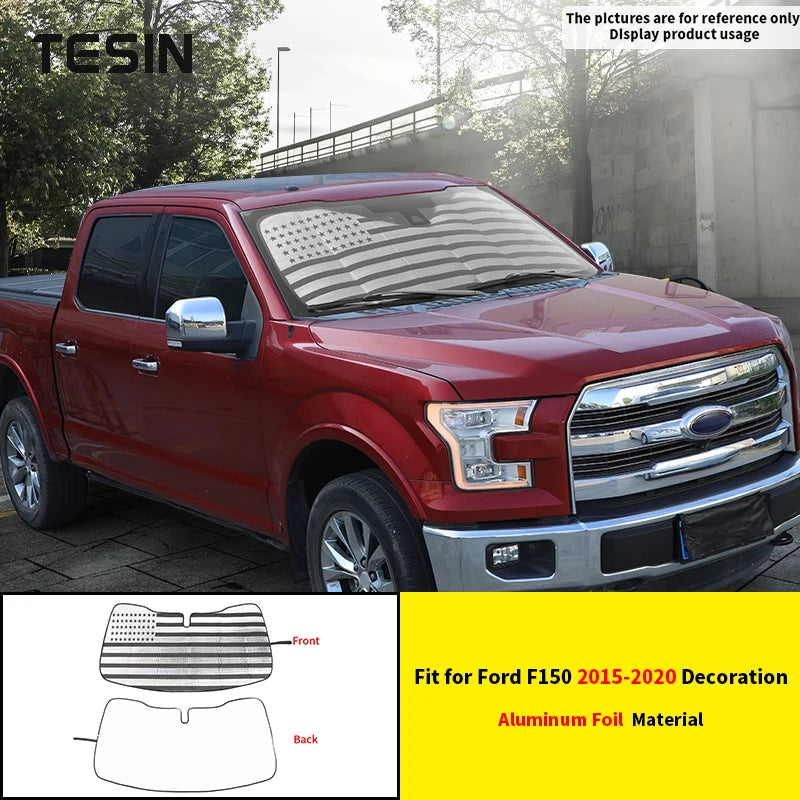 Aluminum foil windshield sunshade for a red Ford F150 truck.