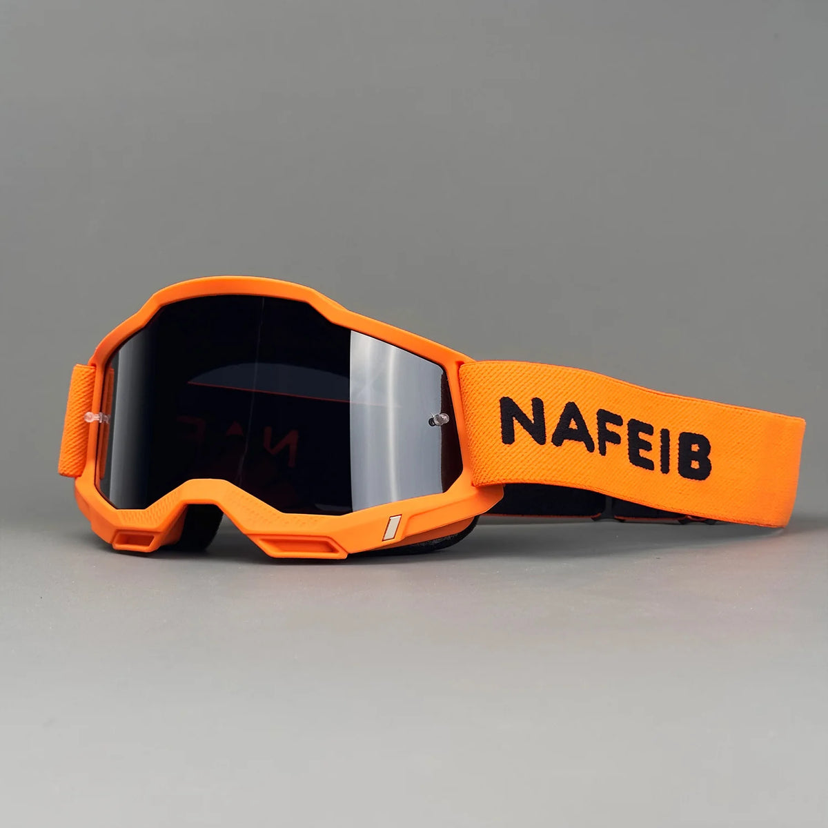 Orange off-road racing goggles with a black lens and an adjustable strap marked NAFEIB