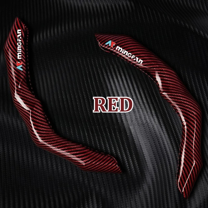 Red carbon fiber steering wheel cover displayed on a black textured surface.