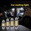 Un jeu de quatre lumières LED Canbus pour la lecture, affichées devant l'intérieur d'une voiture.