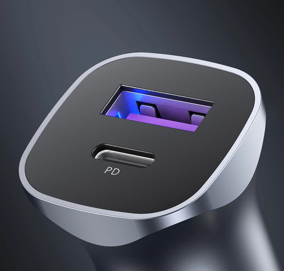 A silver car charger with a translucent purple light visible through the port and a PD indicator.