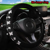 Black steering wheel cover with a glitter butterfly pattern installed in a car interior.