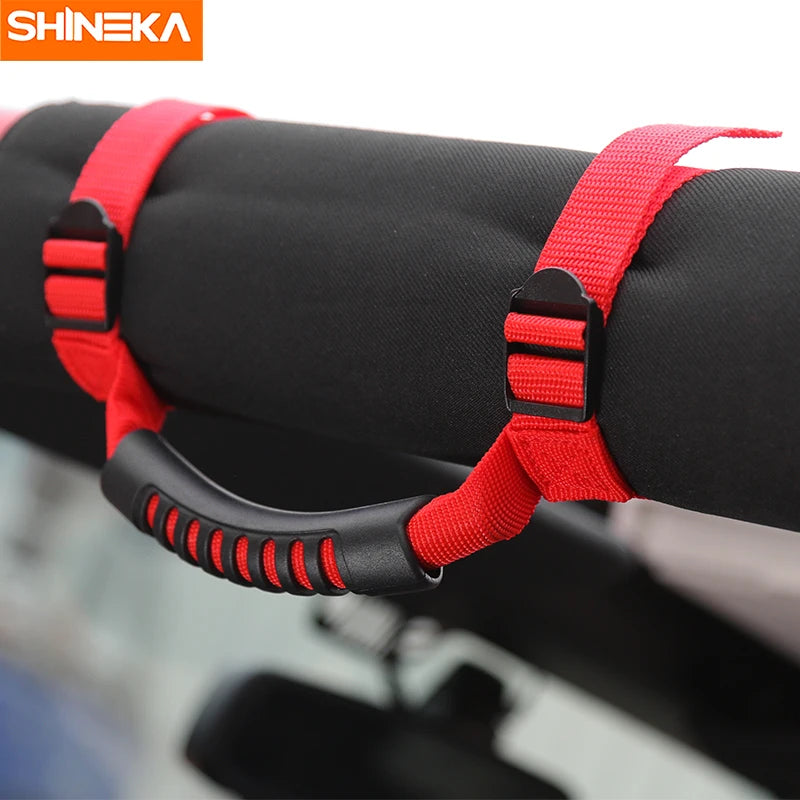 Red grab handles for a vehicle roll bar or Jeep, designed for off-road use.